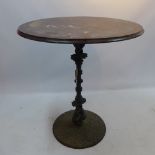 A cast iron pub table with turned column and twin dolphin support,