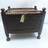 A 17th century oak Afghan chest with hinged lid and carved front,