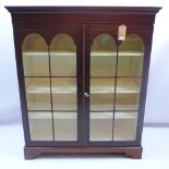 A 19th century mahogany bookcase with two astral glazed doors and raised on carved bracket feet,