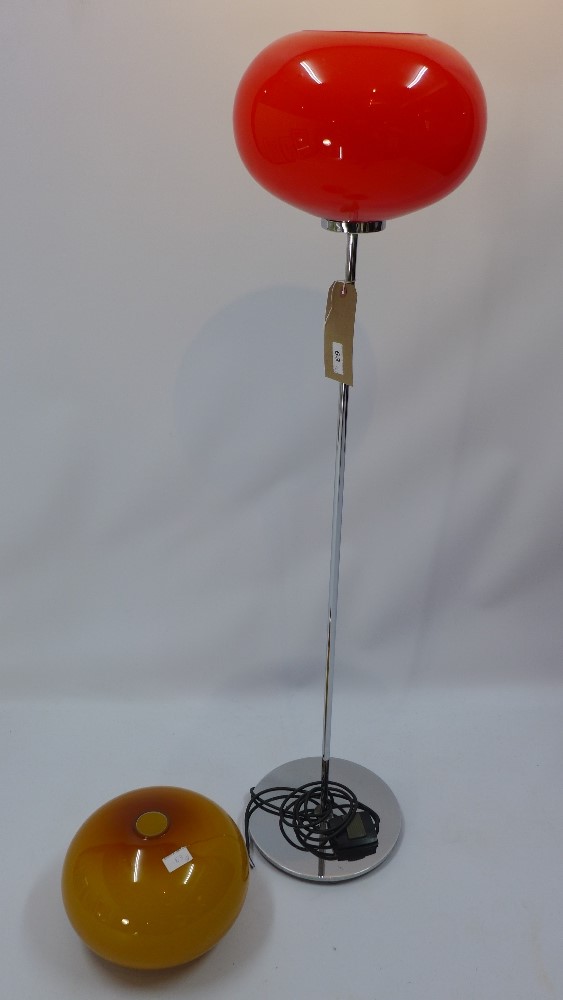 A vintage chromed standard lamp having a red glass shade together with an additional spare shade,