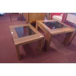 A graduated pair of Marks and Spencers low tables having smoked glass inserts,