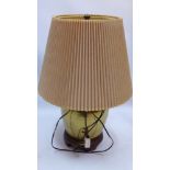 A Chinese style brass table lamp of ovoid form and raised on carved hardwood base,