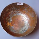 An 18th century Persian tin plate on copper bowl having repeated engraved decoration,