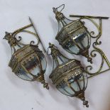 A set of three wall hanging storm lanterns in the classical taste,