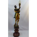 A large Blackamoor lamp modelled as a figure holding aloft a torch,