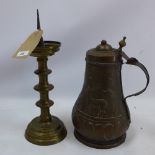 A 19th century copper flagon and 18th century pricket candlestick