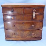 A Victorian mahogany bow fronted chest of two short over three long drawers and raised on bun feet