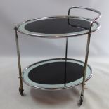 A Chrome circular drinks trolley with black glass insets