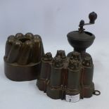 Two antique jelly moulds and 19th century coffee grinder