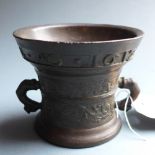 An antique bronze mortar with inscription and dated 1612