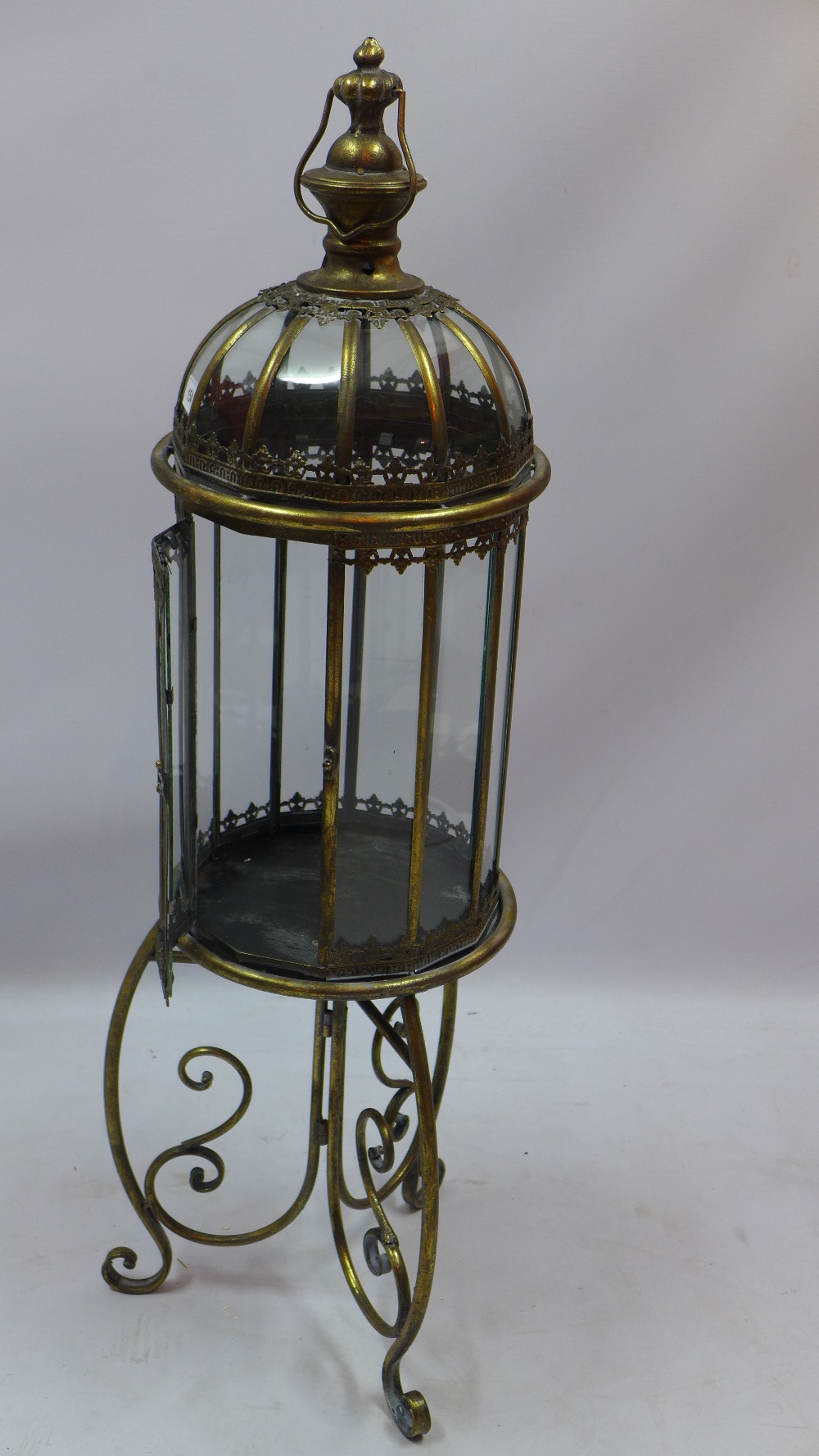 A tall brass Indian style lantern on sta