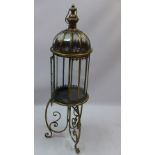 A tall brass Indian style lantern on sta