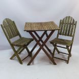 A teak garden table and two chairs