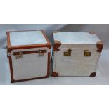 A near pair of Andrew Martin aluminium trunks with twin handles and leather detail,