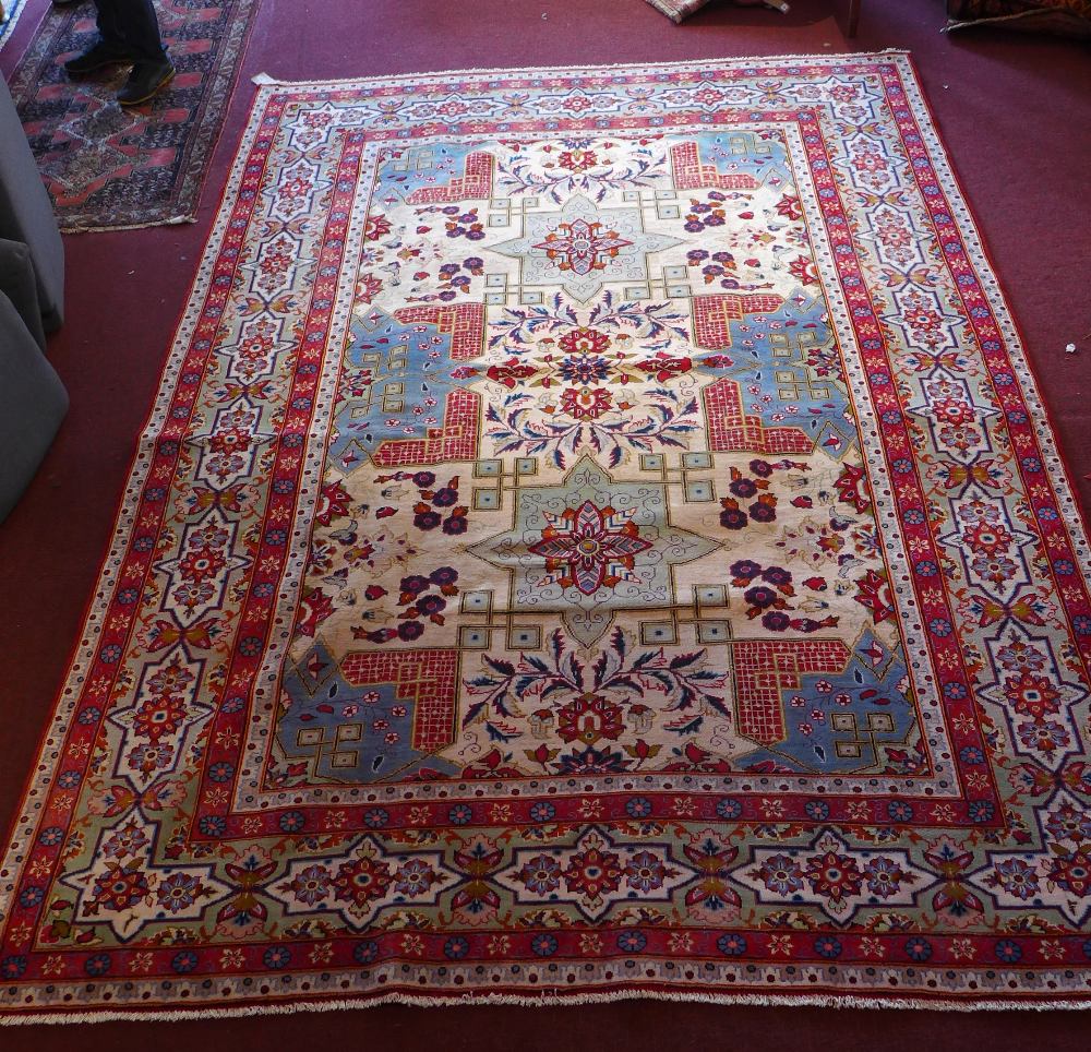 A central Persian Isfahan carpet 352 x 243cm with repeating stylised eagle Kazak motifs and