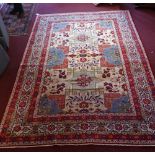 A central Persian Isfahan carpet 352 x 243cm with repeating stylised eagle Kazak motifs and