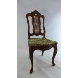 A 19th century walnut chair with pierced and caned back and embroidered seat raised on cabriole