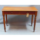 A Victorian mahogany side table with two drawer and raised on turned legs,