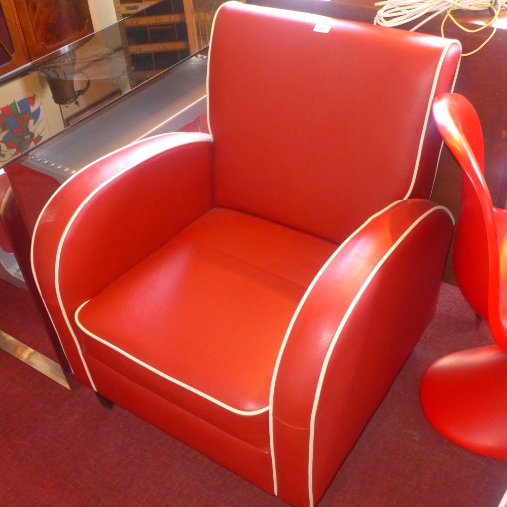 An Art Deco style burgundy leather armchair with white piping and raised on square tapered legs H