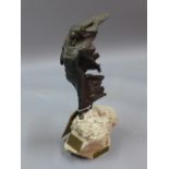 A 20th century resin sculpture of a woman on a rocky outcrop, designed by Josep Bofill,