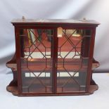 A 19th century mahogany mirrored back wall hanging display cabinet,