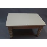 A grey painted rectangular pine low table raised on turned supports H 46 x W 91 x D 61cm