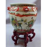 A 20th century Chinese famille vert jardiniere on wooden stand,