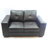 A contemporary black leather two seater angular form sofa