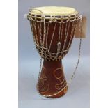 A carved wooden bongo drum,