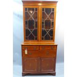 An Edwardian mahogany bookcase with marquetry inlay having two drawers above one long drawer and