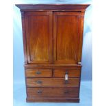 A Georgian mahogany linen press having two cupboard doors over two short and two long graduated