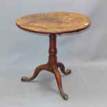 A Georgian burr elm circular occasional table raised on tripod supports,