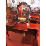 A mahogany dressing table raised on cabriole supports and castors,