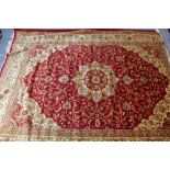 A Keshan style carpet with a medallion on a red field,