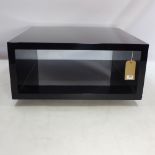 A contemporary black lacquered coffee table,