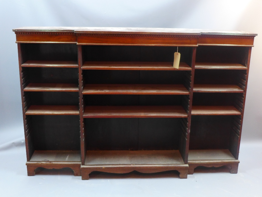 A 19th century mahogany break front open bookcase with adjustable shelves and raised on carved