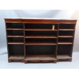 A 19th century mahogany break front open bookcase with adjustable shelves and raised on carved