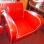 An Art Deco style red leather armchair with white piping on bun feet H 78 x W 77 x D 85cm