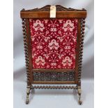 A 19th century rosewood fire screen with barley twist supports and stretcher raised on hoof feet