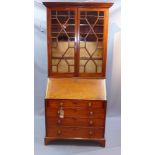 A 19th century bureau bookcase with astragal glazed doors above drop flap,