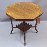 A Victorian rosewood octagonal occasional table raised on splayed legs and castors joined by