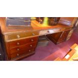 A 19th century mahogany partners desk with an arrangement of twenty drawers and fully fitted