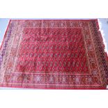 A Bokhara style carpet with goul motifs on a red field surrounded by many borders 230 x 160cm