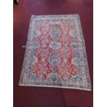 A fine Continental Persian part silk Nain rug having all over petal and spandrel motifs on a rouge