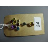 A silver pendant set with blue topaz, amethyst, amber quartz and peridot.