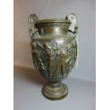 A 19th Century twin handled bronze urn, relief decorated with classical figures.