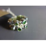 A nobbly silver ring set with diopside stones.