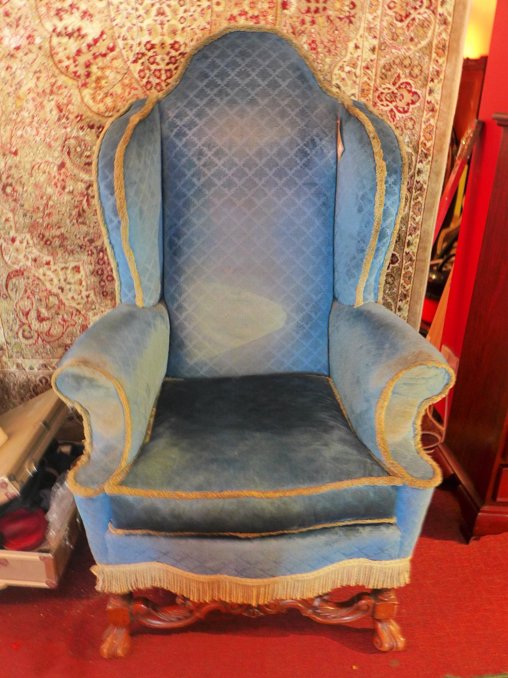 A late 19th Century Queen Anne style walnut wing back armchair with blue upholstery,