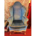 A late 19th Century Queen Anne style walnut wing back armchair with blue upholstery,