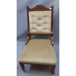 A Victorian mahogany button back salon chair with scallop shell cartouche raised on castors H 99cm